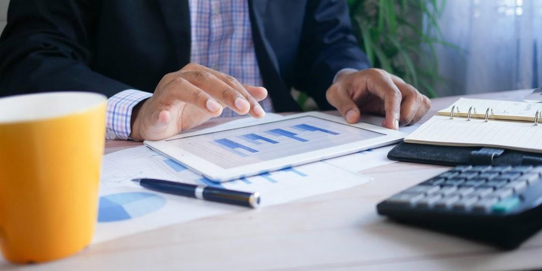 A person reviewing automated finance reports and data charts to boost efficiency